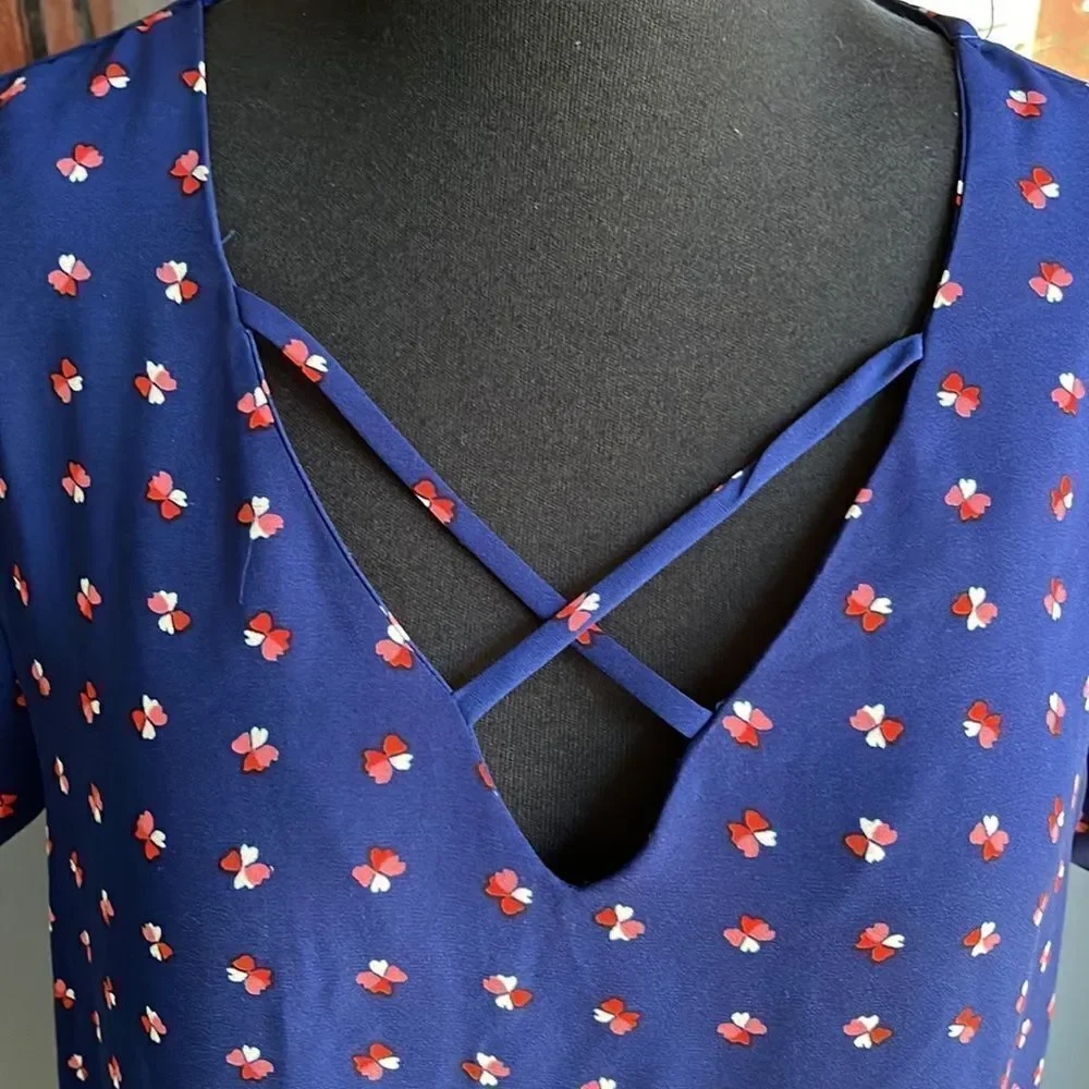 Lily White navy tiny heart flowers pattern X neckline top. Medium.